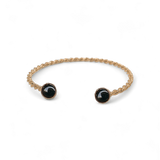 Bracelet jonc Paul plaqué or cabochon onyx noir fait main à Paris, porté au poignet